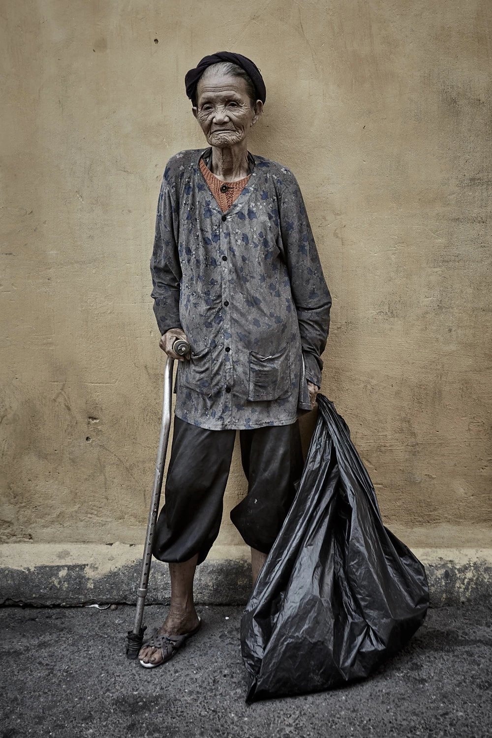 portrait of a Vietnamese woman who collects garbage