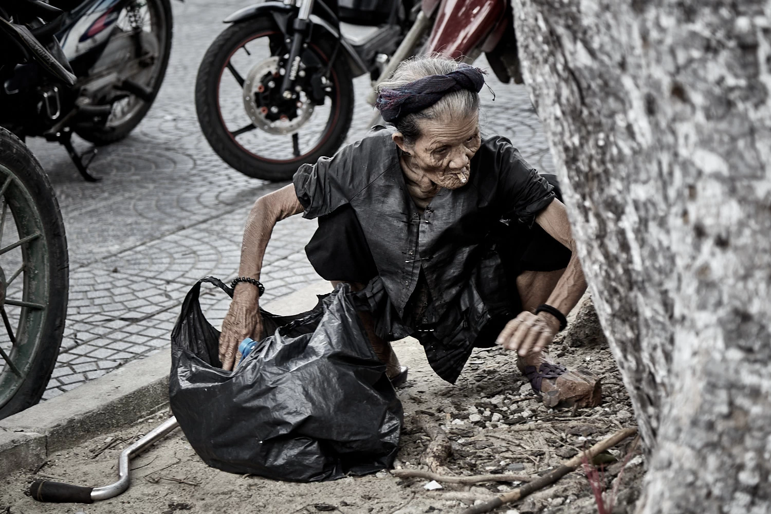 Vietnamese woman searching for anything of value