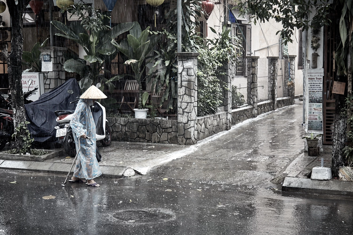 Old Vietnamese woman looking for trash
