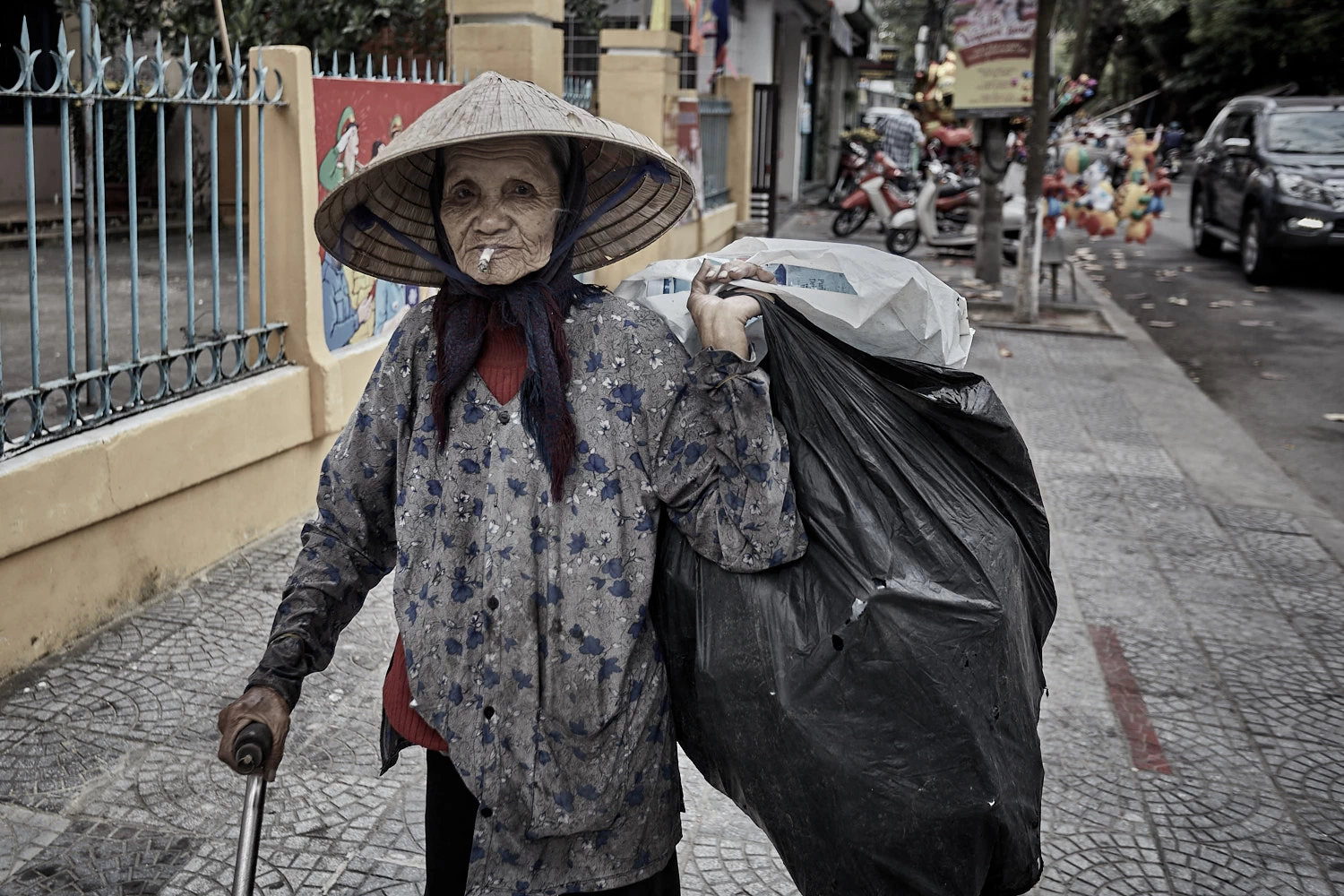 Vietnamese woman collecting empty bottles
