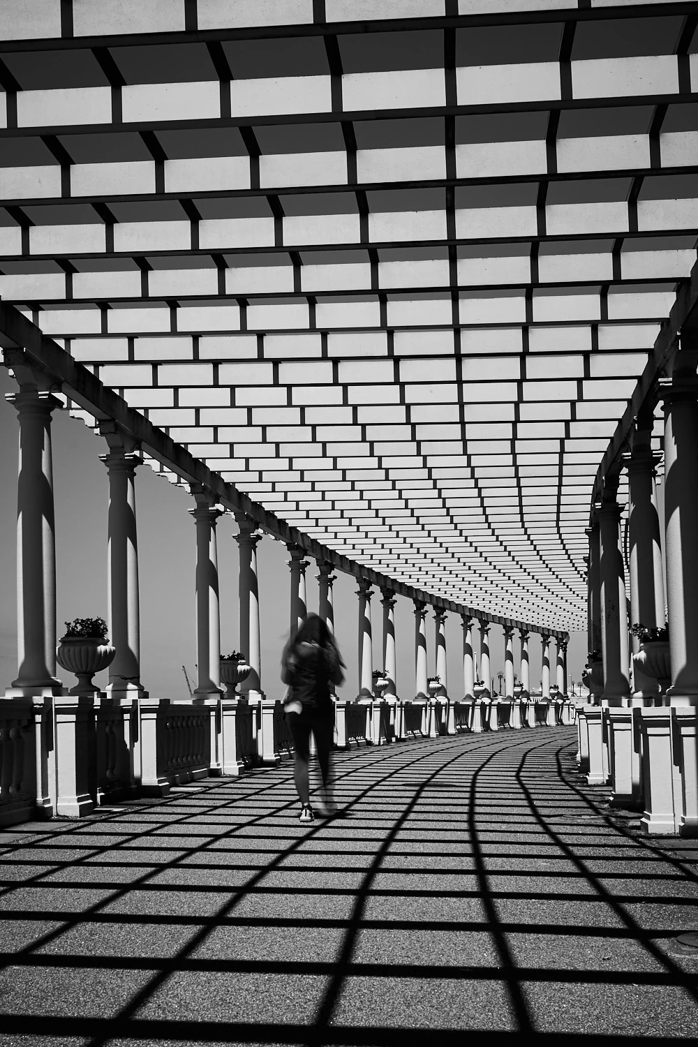 Blurry woman walking at Pergola Da Foz, Porto