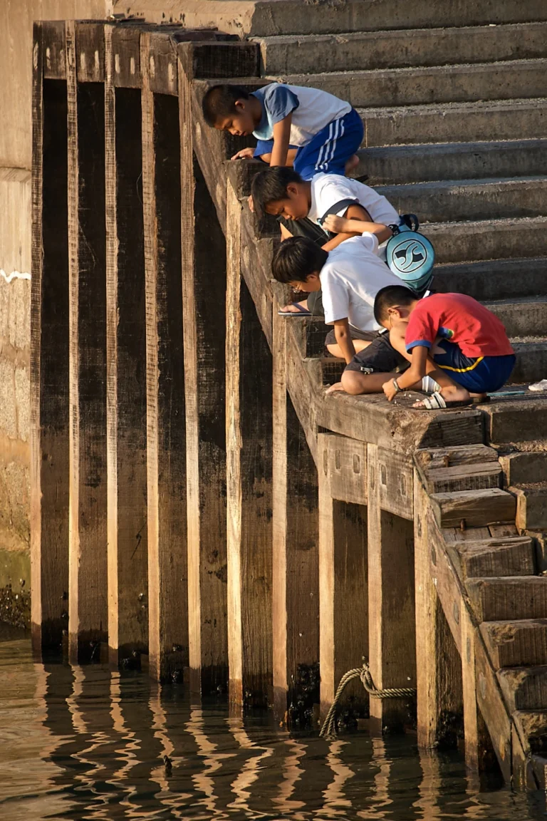 Boys looking down the lines of a pier in Hong Kong