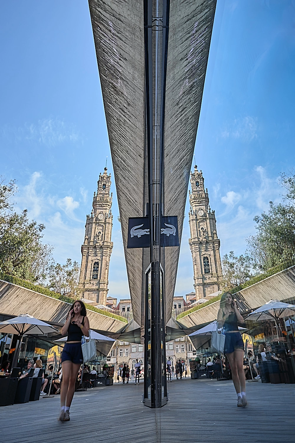 A woman with Clerigos tower in the background mirrored.